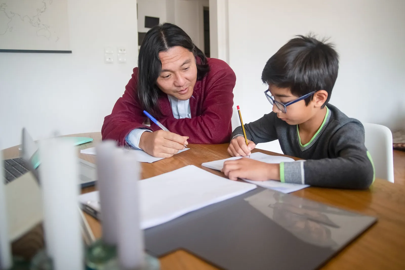 A tutor working one to one with a young student at his own pace