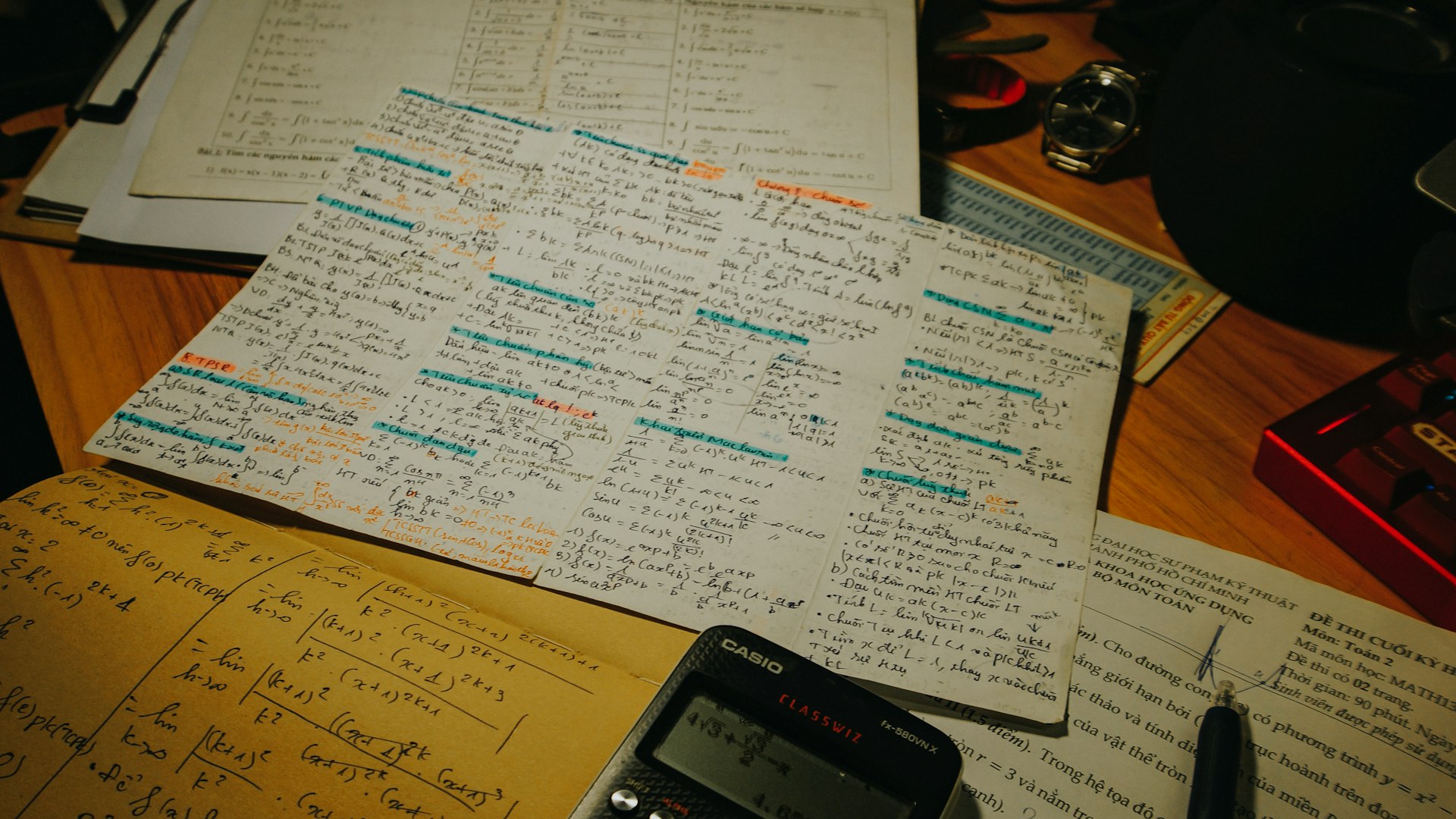 Desk with calculator and papers set up for A-Level study