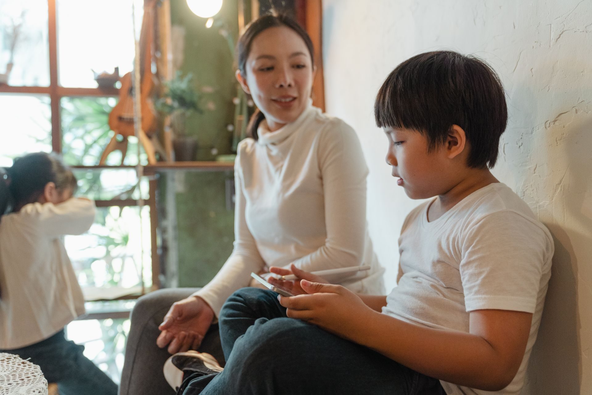 Parent spending time with their children on schoolwork at home