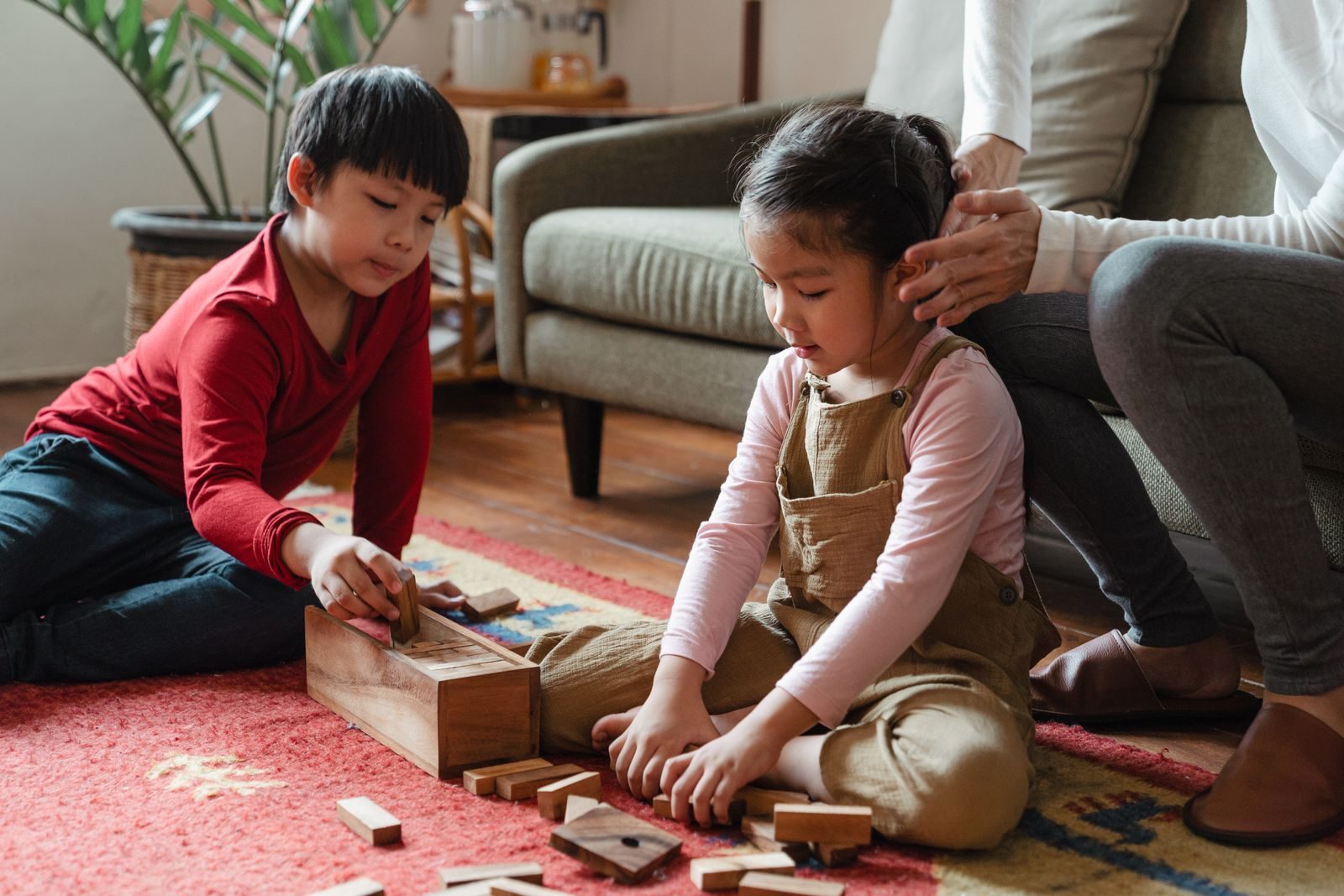 Young children building with wooden blocks at a preschool table