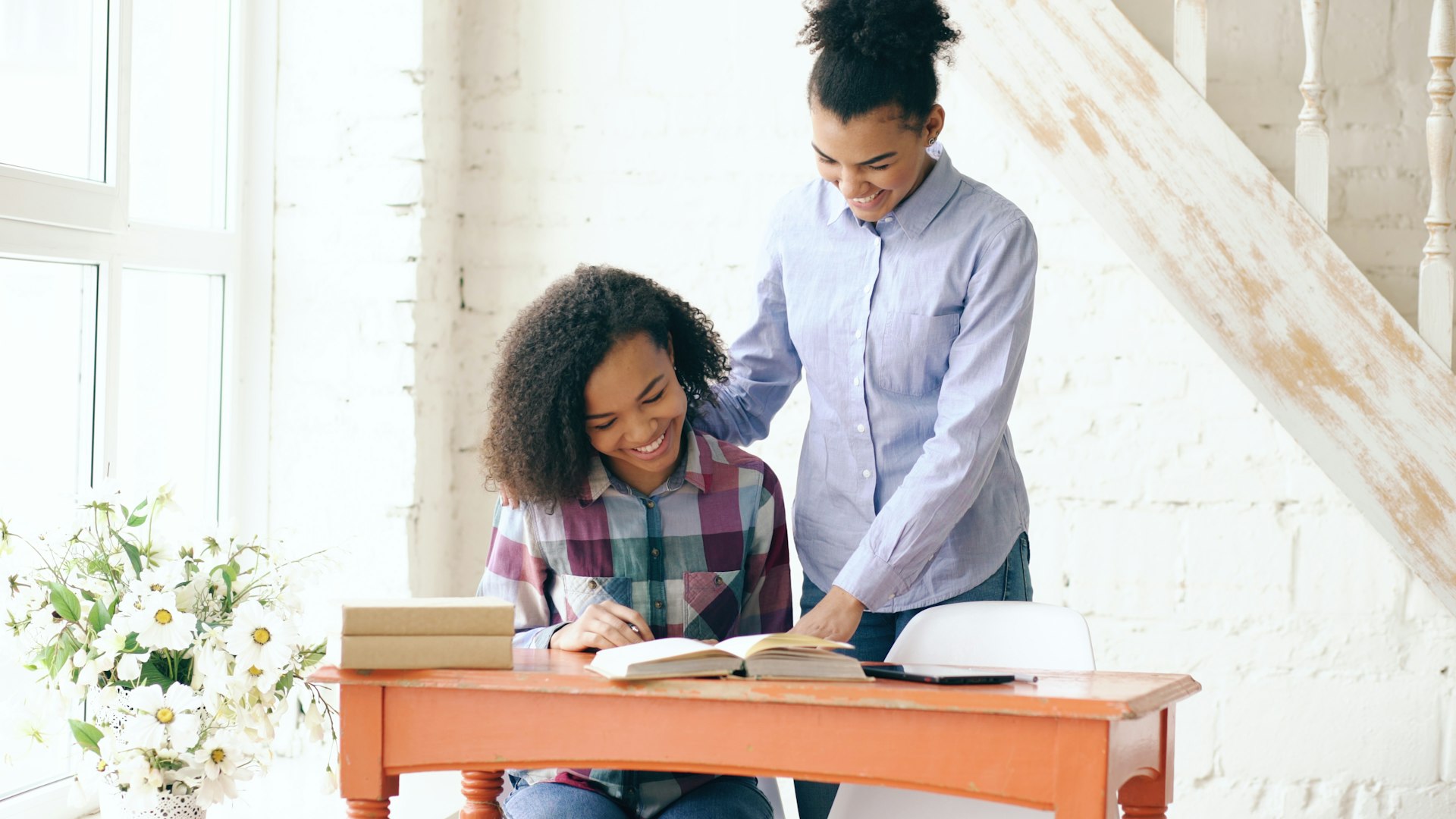 Tutor and student working on English reading comprehension together