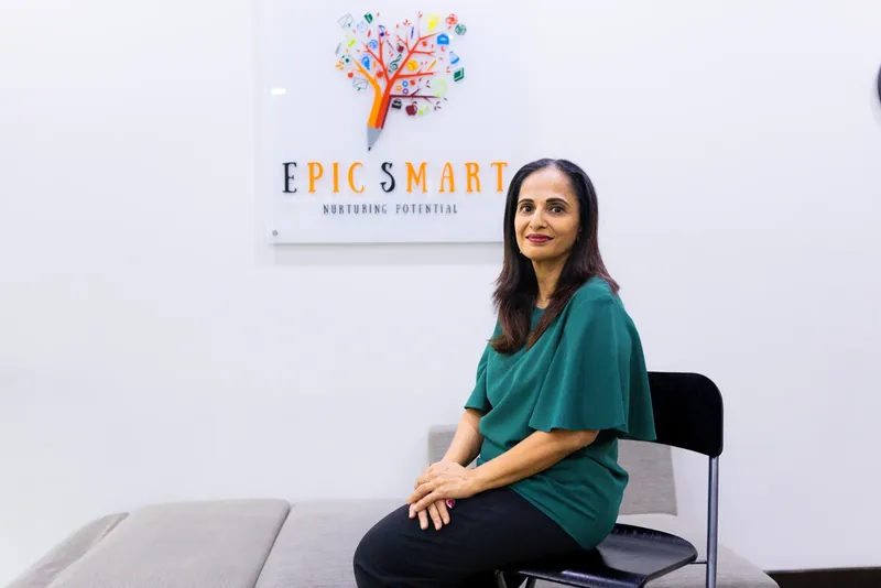 Mrs Mayurni Patel, founder of Epic Smart Academy, seated beneath the centre's logo in Bangsar