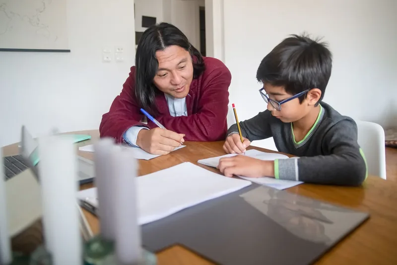 A tutor working one to one with a young student at his own pace