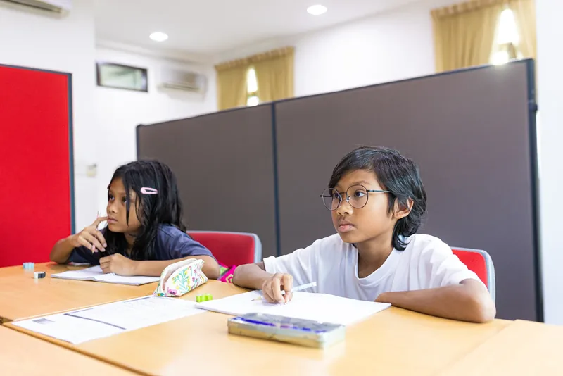 Young primary students focused on their work in class at Epic Smart Academy, Bangsar