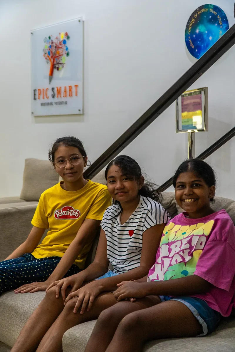 Three students relaxing in the welcoming lounge of Epic Smart Academy in Bangsar