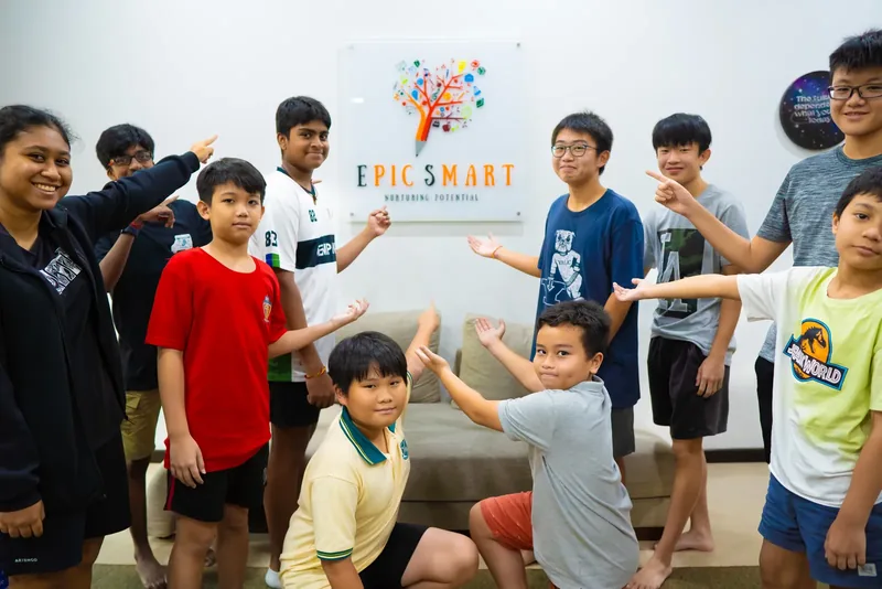 Students proudly presenting the Epic Smart Academy sign inside the Bangsar centre