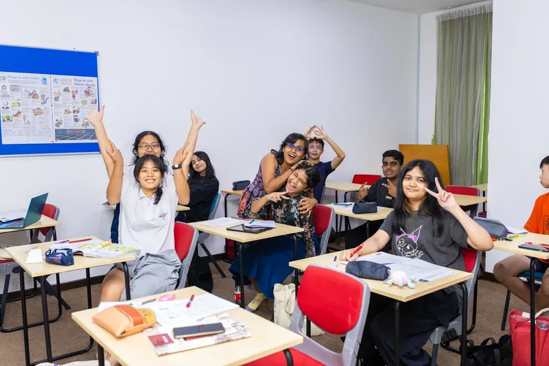A teacher sharing a joyful moment with her students in a classroom at Epic Smart Academy in Bangsar