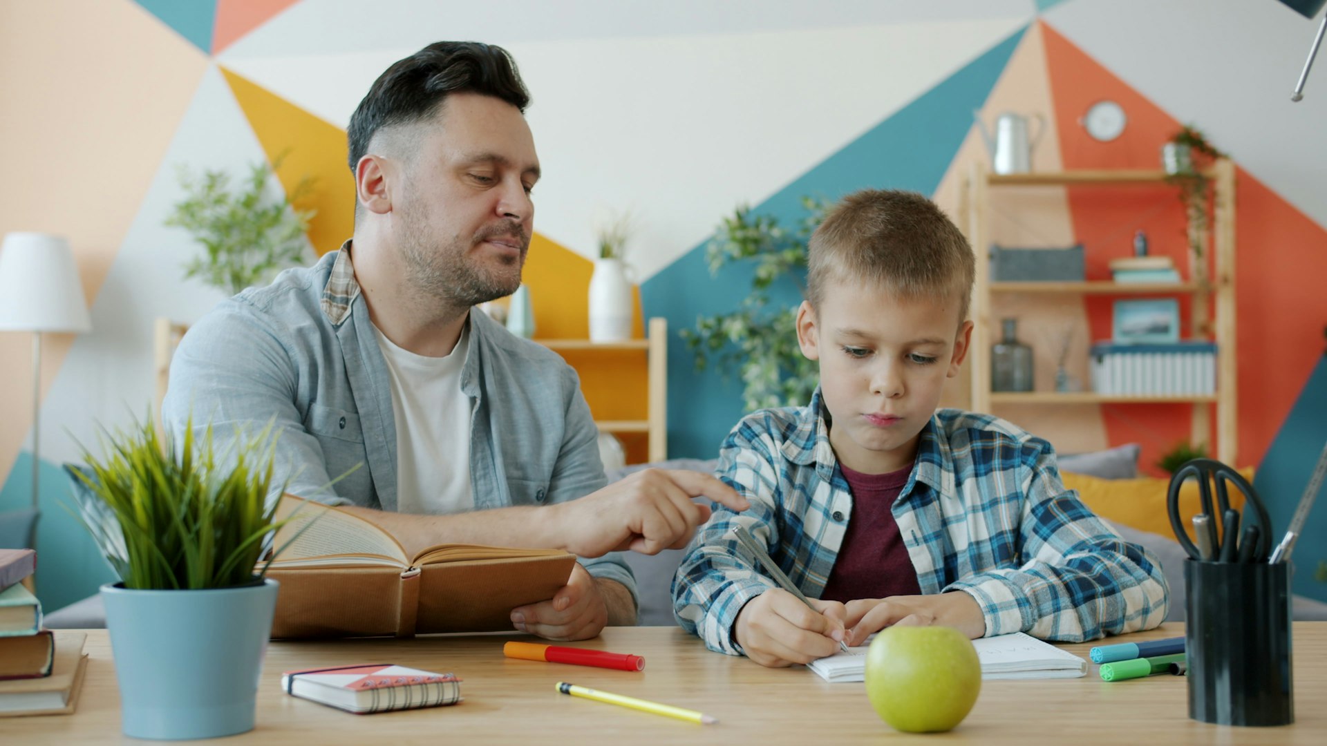 Parent helping a child with homework before starting formal tuition