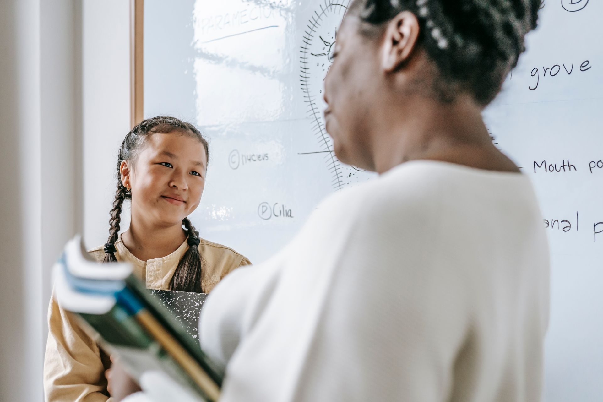 Student smiling with their teacher during a tuition session