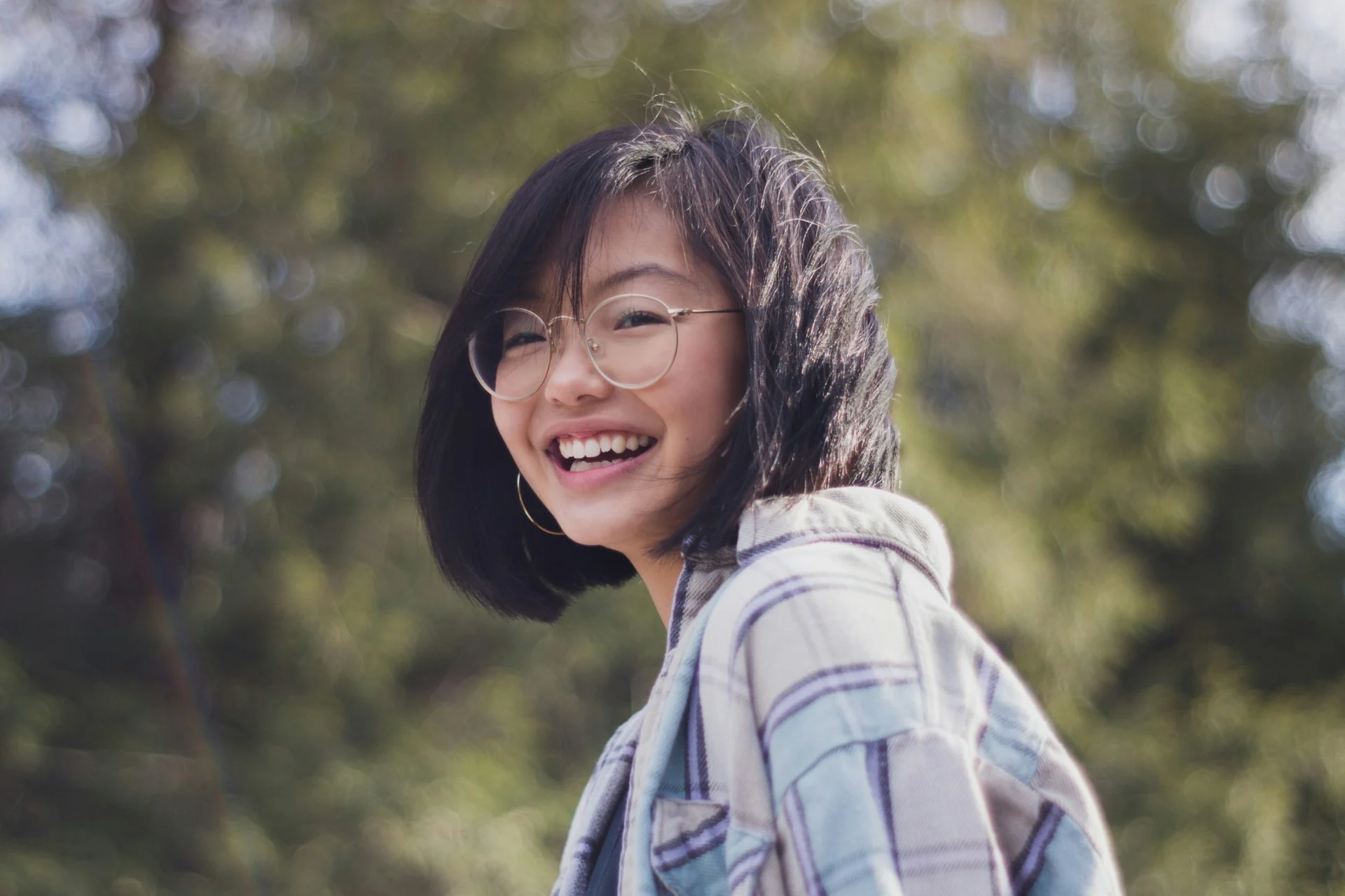 Pre-university student with glasses smiling outdoors