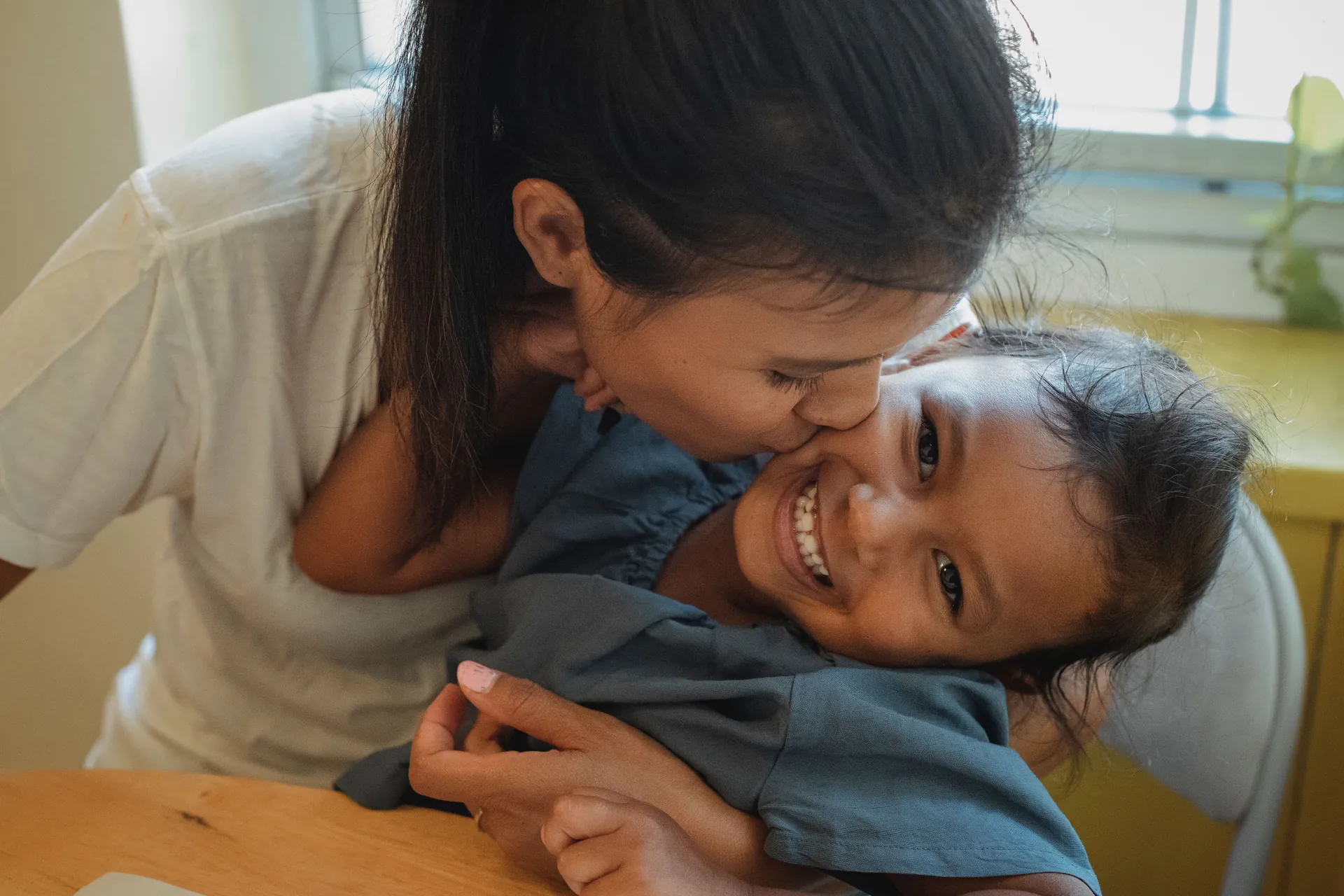 A parent and young child reading a book together