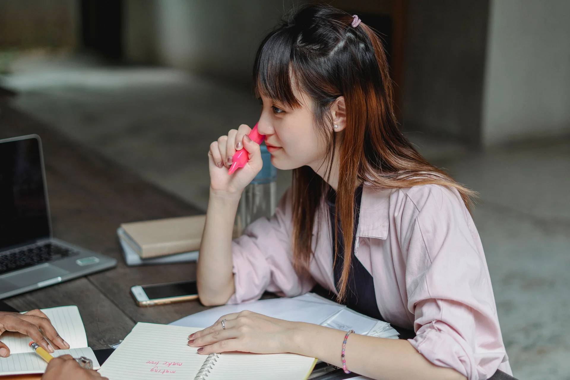 A student working in a notebook with a marker