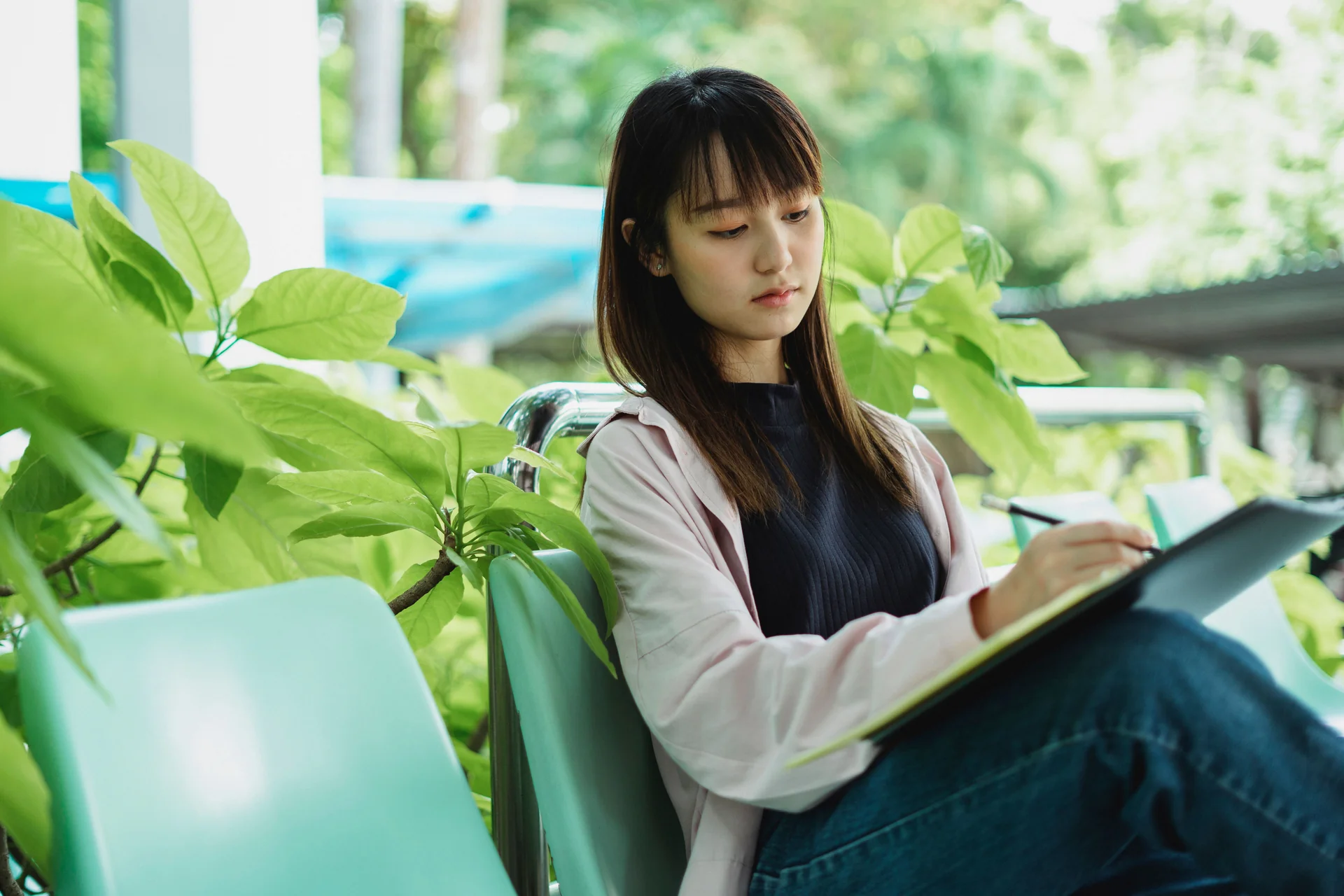A student writing notes while studying