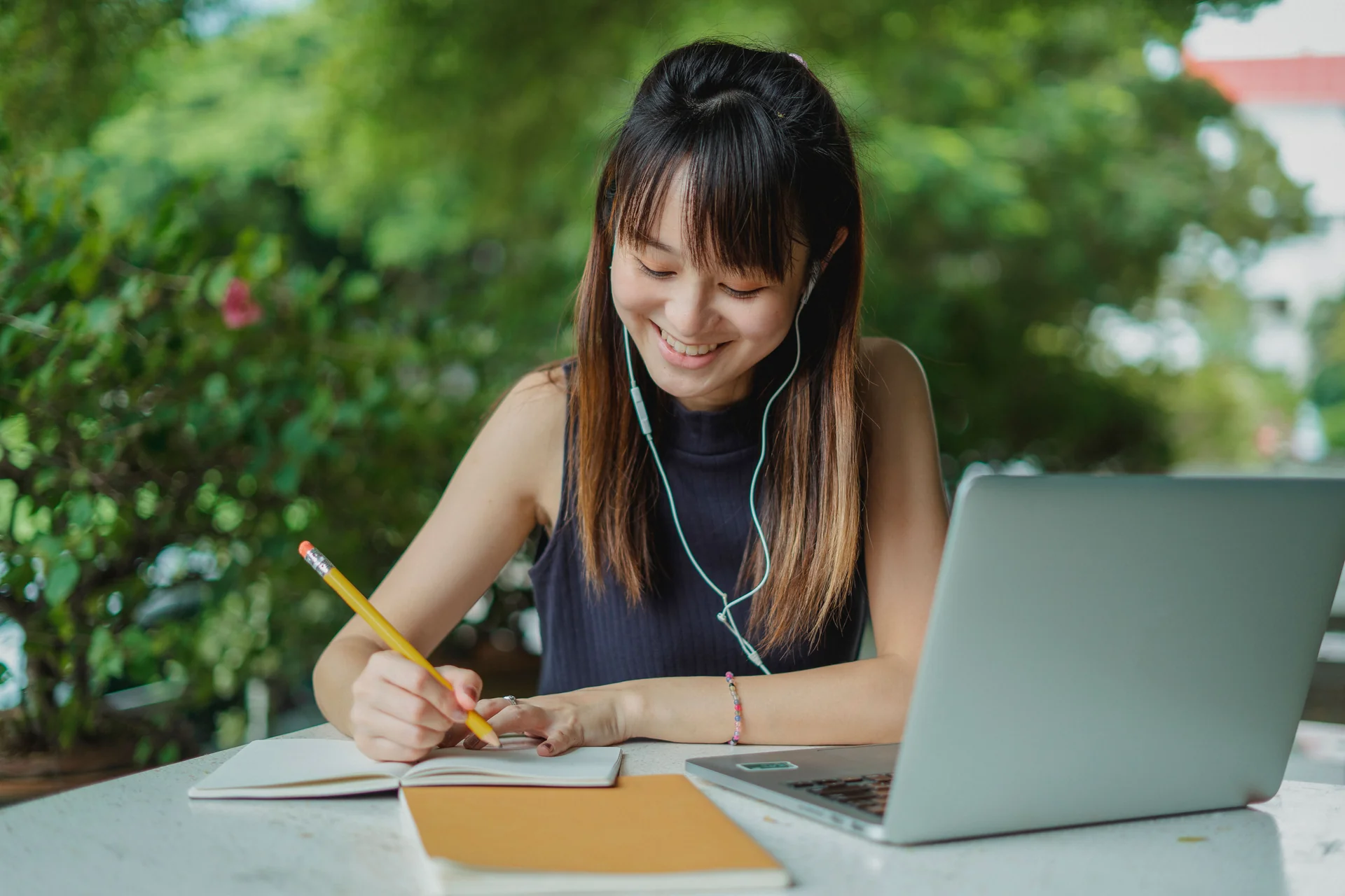 A student doing homework while wearing earphones